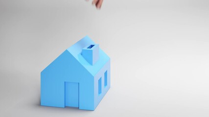 Wall Mural - saving for your own house or apartment concept: a hand dropping golden coins into the chimney of a m