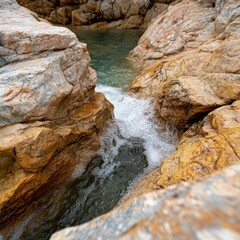 Aufkleber - Water flowing between orange brown jagged rocks and a glimpse of turquoise water creates dynamic contrast and a feeling of natural harmony