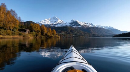 Aufkleber - Kayak perspective on a calm lake with autumn trees snow capped mountains and a clear blue sky reflecting in the water