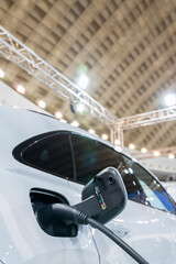 Aufkleber - Close up of electric car inlet with a connected charging cable