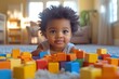 © Tanu - Child playing with colorful blocks in a cozy living room during afternoon light