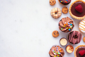 Leinwandbilder - Dessert side border with a variety of sweets. Top view on a white stone background with copy space.