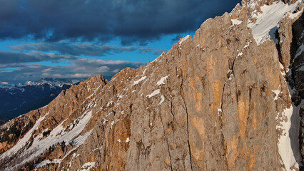 Wall Mural - rocky snow mountains at sunset aerial