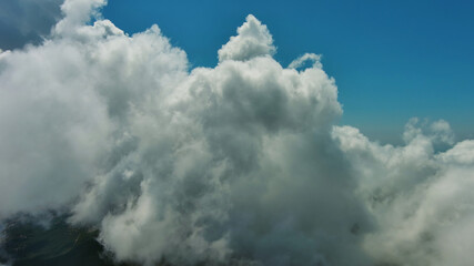 Wall Mural - flying through white fluffy clouds