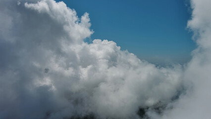 Wall Mural - flying through white fluffy clouds