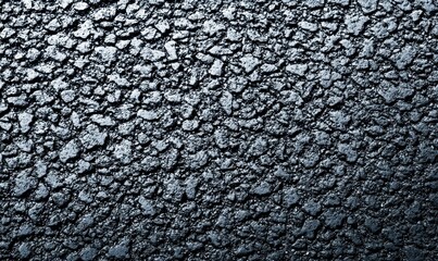 Poster - Dark, freshly laid asphalt shows its intricate, rough texture with subtle light reflections.