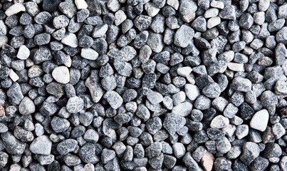 Poster - An overhead view shows a pile of decorative gray pebbles for landscaping and construction.