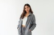 © ThomasLENNE - Half-Length (Waist-Up) portrait of young stylish smiling Yemeni female model in sporty wear isolated on pure white background looking at camera