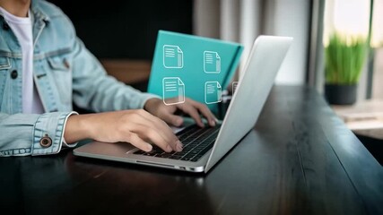 Poster - Person typing on a laptop with document icons overlayed on a blue folder behind it on a desk