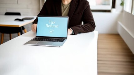 Poster - Person at desk with laptop showing tax refund message and check mark on the computer screen indoors