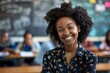 © Baba Images - Portrait of a young smiling African American female teacher in front of a classroom