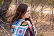 © Austockphoto - Young woman in winter scenery with crochet blanket and woolen jumper