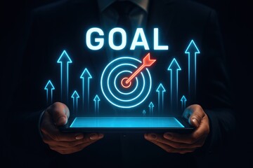 Poster - Achieving the Goal: A person holding a digital tablet displaying a glowing target with the word 
