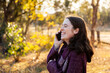 © Austockphoto - Young woman outside talking on mobile phone
