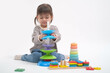 © Bordinthorn - Young child playing with colorful educational toys, focusing intently as she explores and learns. Ideal for illustrating early childhood development.