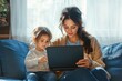 © lucky - Mother and daughter enjoying quality time together while working from home on a laptop in a cozy living room