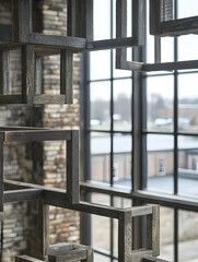  Dark Wooden Cubes Hanging Near Window in Industrial Building