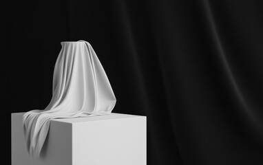 Poster - draped white fabric on a white cube against black background