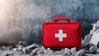 © 69 - A red first aid kit sits on the rubble of a collapsed building, representing emergency care in urban disaster scenarios.
