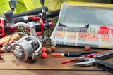Fishing tackle on the table in a composition.