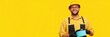 © SerPak - Cheerful young caucasian male worker in yellow uniform holding a toolbox.