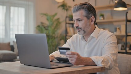 Poster - a person using a laptop and credit card at a desk