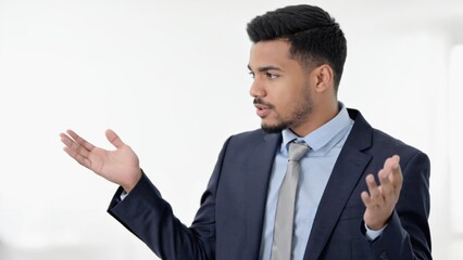 Poster - a professional man in a suit and tie gestures while communicating, suitable for corporate or financi