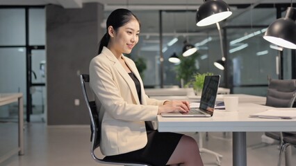 Poster - A person sitting at a desk with a laptop, possibly working or browsing
