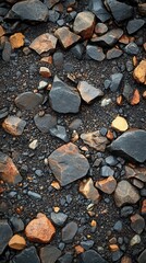 Poster - Rugged Stone Arrangement on Dark Volcanic Sand Creates a Natural Textured Background for Design Projects
