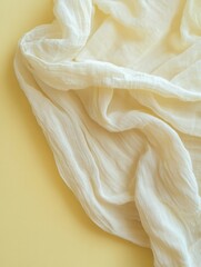 Poster - Elegant Creamy Fabric Drape on Soft Yellow Background Capturing Subtle Textures and Delicate Folds for Serene Visual Appeal and Versatile Design Applications