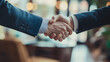 © Fonlinepix - Businessman and client shaking hands after agreeing on a major project, in an upscale conference room.