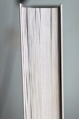 Poster - A close-up shot of a book sitting on a table, perfect for illustrating a reading scene or academic setting.