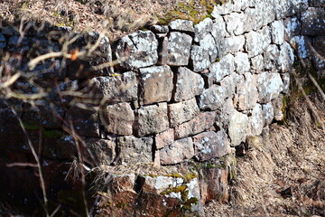 Poster - Old stone wall overgrown with moss and lichen.