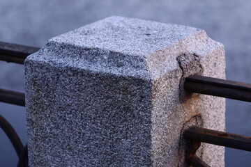 Aufkleber - A close-up shot of a metal fence with a stone block attached, suitable for use in architectural or decorative contexts.