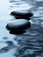 Aufkleber - Close-up view of smooth black river stones on wet reflective surface with soft lighting and deep contrast, showcasing minimalist nature texture