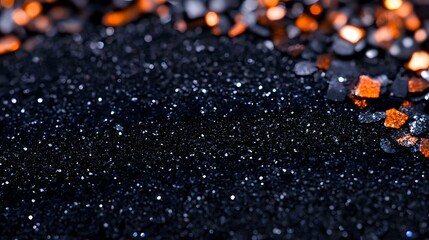 Poster - Glittering black background with scattered orange crystals and sparkles creating magical contrast. Dark moody surface with bokeh light effects and shimmering texture.