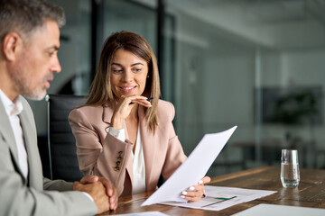 Fototapete - Legal consultancy concept. Business woman lawyer attorney showing document to man client providing advisory services, professionals discussing tax papers working in office at meeting.
