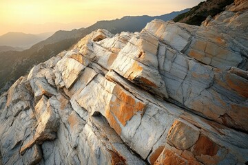 Poster - Striking image of layered rock formations on a mountainside, bathed in soft light during golden hour, showcasing natural beauty.