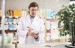 © JackF - Man pharmacist makes restock, uses paper carrier of information. Checking availability of drugs, determining actual quantity of goods in warehouse.