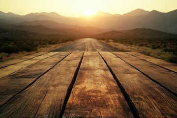 Aufkleber - A wooden deck overlooks a distant road winding through mountains at sunset with warm lighting.