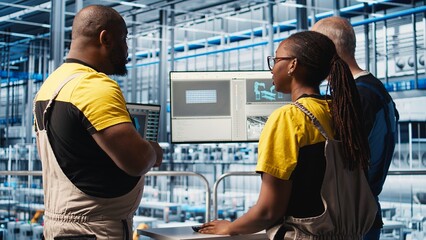 Poster - smart photovoltaics factory staff members brainstorming, looking at system performance metrics. sola