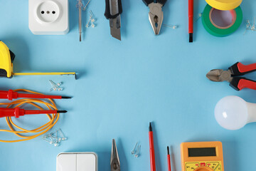 Poster - Frame of different electrical tools on light blue background, flat lay. Space for text