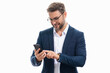 © Volodymyr - Handsome business man talking on phone. Business man in suit using smart phone isolated over studio background. Portrait of cheerful guy using cell phone, browse social media on phone.