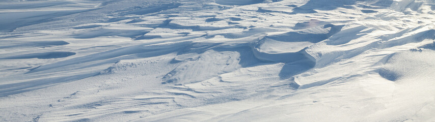 Wall Mural - snow texture. wind sculpted patterns on snow surface. wind in the tundra and in the mountains on the