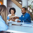 © Dragana Gordic - Diverse Professionals Smiling While Sealing a Deal During a Meeting