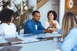 © Dragana Gordic - Diverse Business Team Smiling During an Office Meeting and Handshake