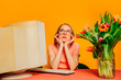 © Westend61 - Businesswoman dreaming at her desk with a vintage computer and tulips