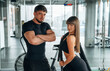 © standret - Standing and posing. Man and woman are in the gym together