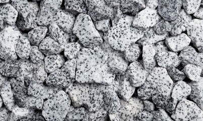 Poster - A textured full frame view shows a pile of rough crushed granite stones in black and white.