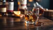 © OM - Bourbon glass sits on wooden bar with ice and refreshing citrus slice during evening gathering
